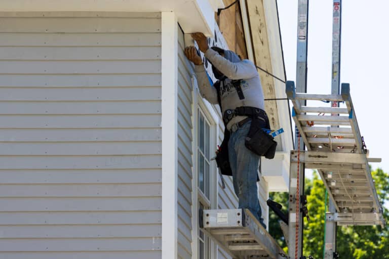 Man replacing the Soffits of a house